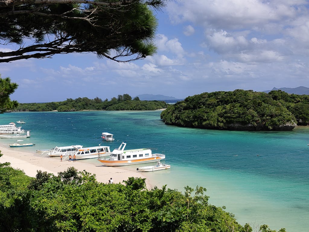 Explore the stunning beaches and turquoise waters of Ishigaki, Okinawa with scenic boat views.